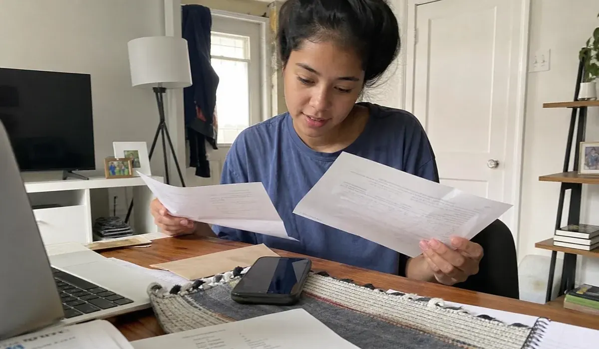 Renter at home reading over a paid in full letter