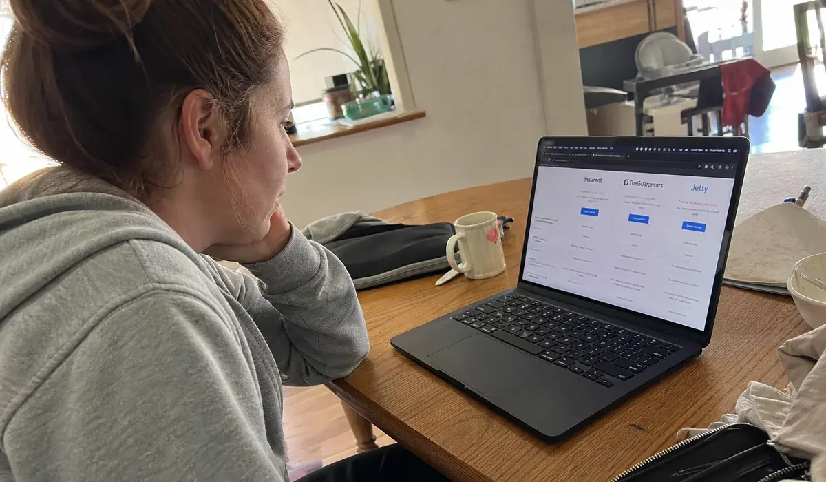 Renter at a laptop comparing guarantor companies